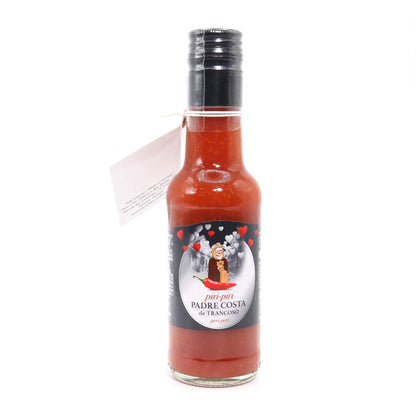 A bottle of Padre Costa de Francisco hot sauce with a black cap and a white hang tag, shown on a plain white background.