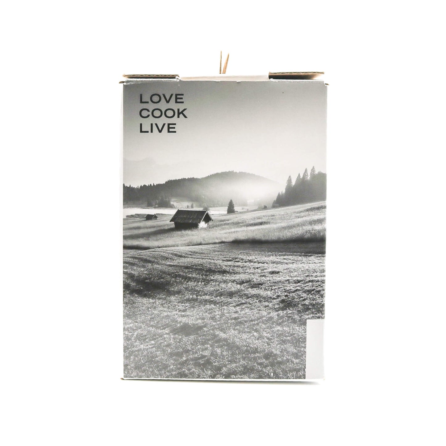 Side of box for citrus press with words 'Love Cook Live' with a black and white landscape on the cover