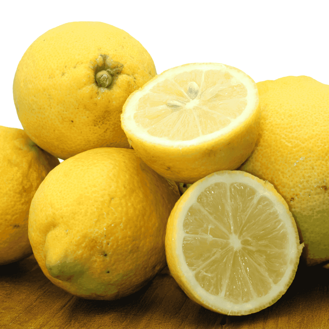 Whole and sliced lemons on a wooden surface with a white background