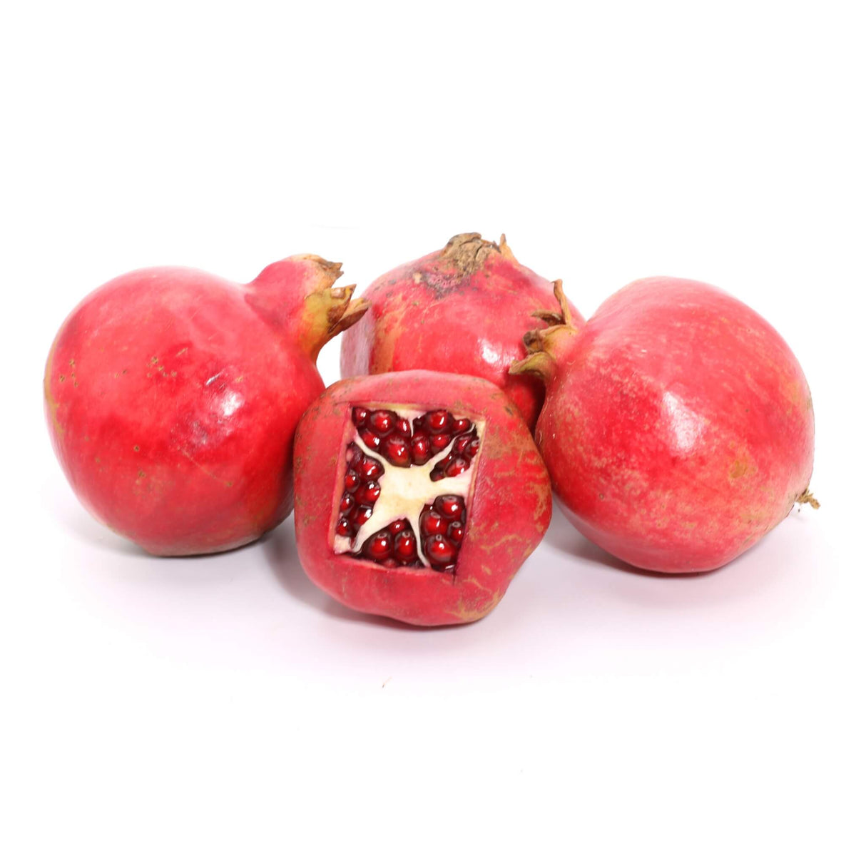 Four red pomegranates on a clean white background, with one cut open to show the seeds.